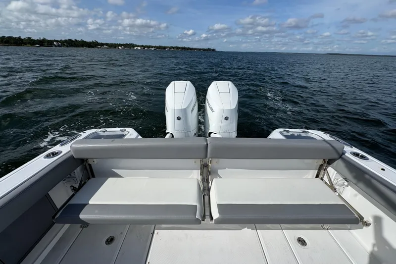 Slide: The Image of 2025 Everglades 315 Center Console boat with dual engines on open water. - 38