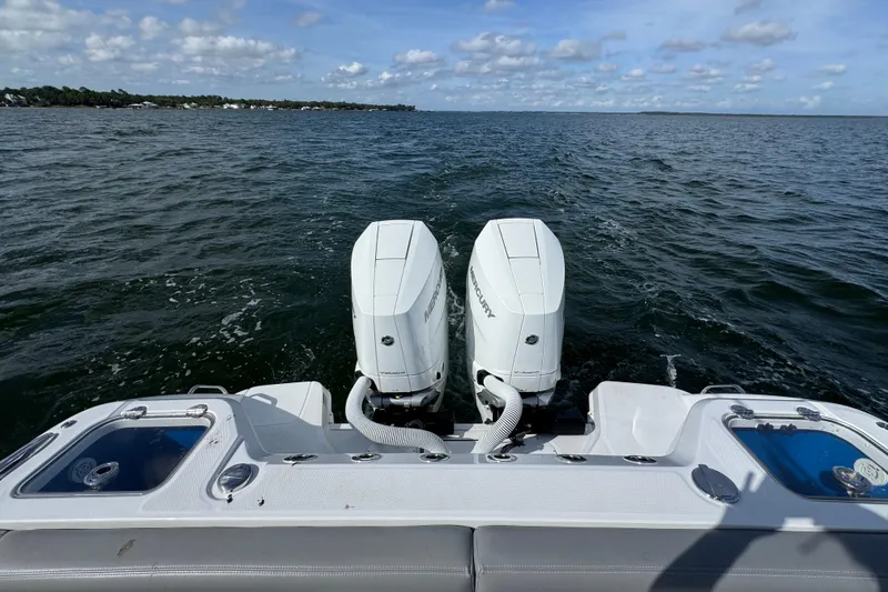 Slide: The Image of 2025 Everglades 315 Center Console boat with dual Mercury engines on open water. - 39