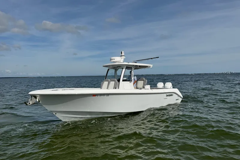 Slide: The Image of 2025 Everglades 315 Center Console boat cruising on open water under clear skies. - 4