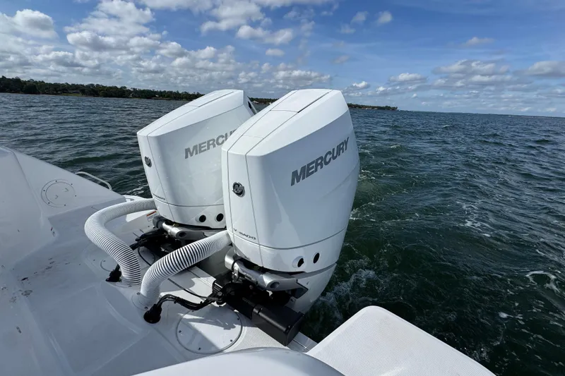 Slide: The Image of Twin Mercury outboard engines on a 2025 Everglades 315 Center Console boat in open water. - 40