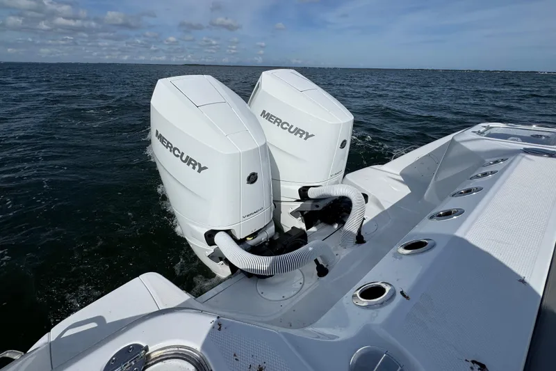 Slide: The Image of Twin Mercury engines on a 2025 Everglades 315 Center Console boat in open water. - 41