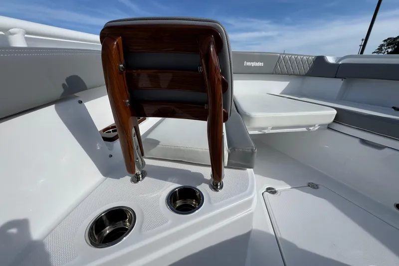 Slide: The Image of 2025 Everglades 315 Center Console boat interior with wooden seat and cup holders. - 42