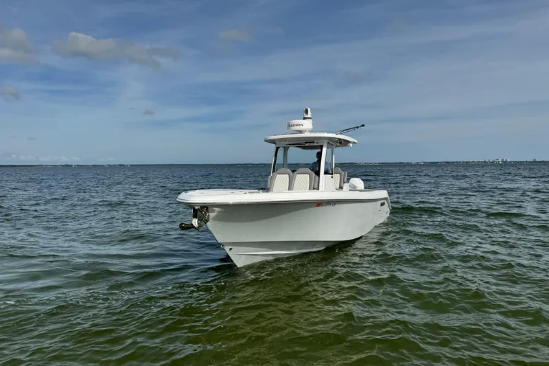 Slide: The Image of 2025 Everglades 315 Center Console boat on open water under clear skies. - 6