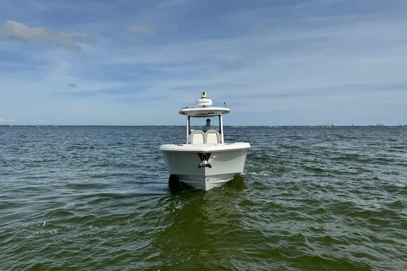 Slide: The Image of 2025 Everglades 315 Center Console boat on open water under clear sky. - 7