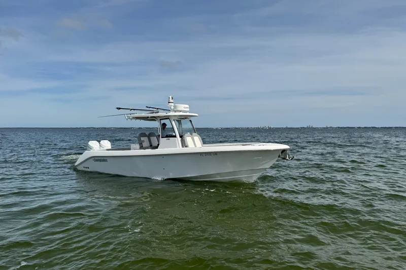 Slide: The Image of 2025 Everglades 315 Center Console boat cruising on open water. - 8