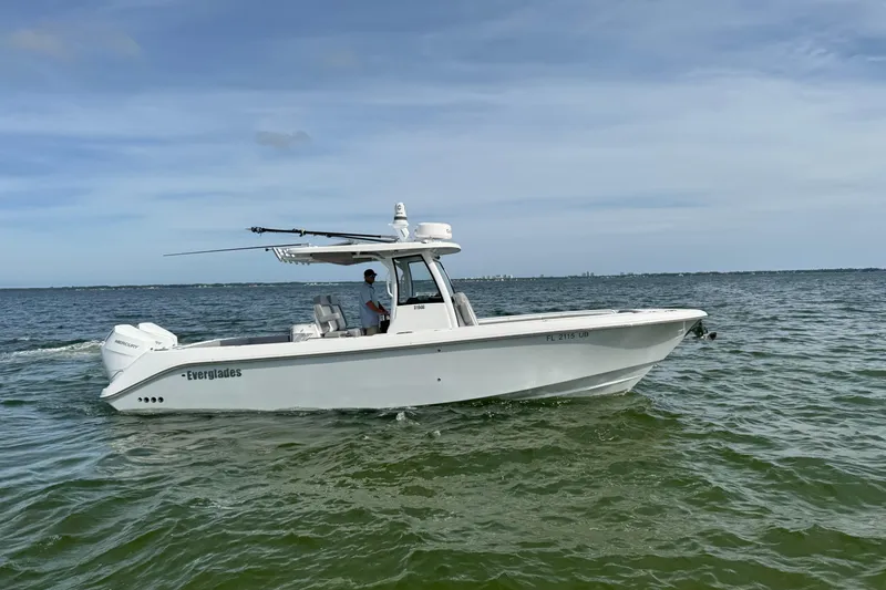 Slide: The Image of 2025 Everglades 315 Center Console boat cruising on open water. - 9