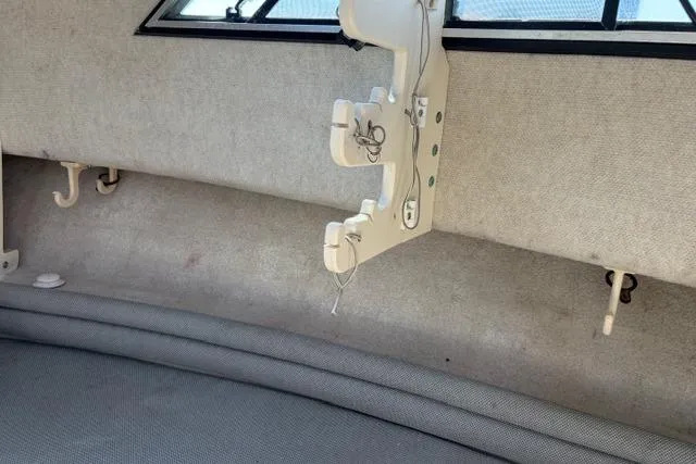 Slide: The Image of Interior of 1994 Grady-White Explorer 244 boat, featuring seating and storage hooks. - 13