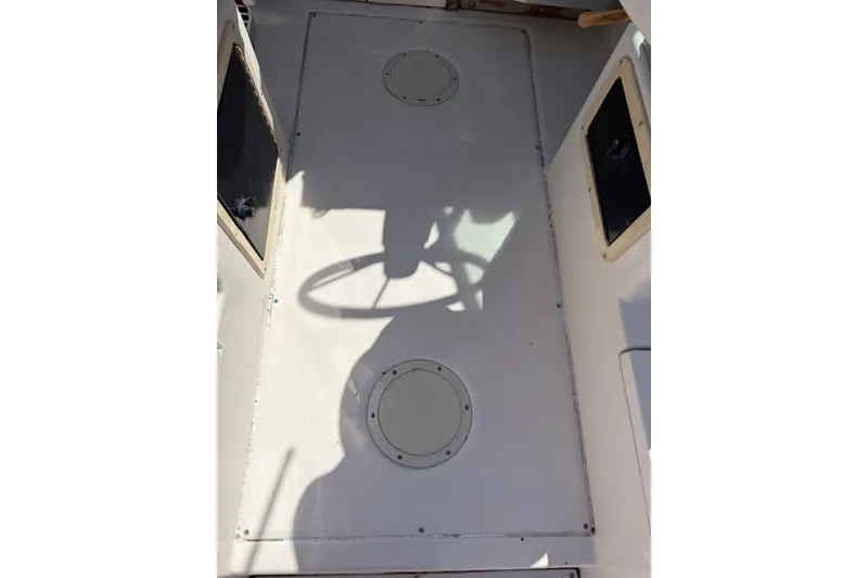 Slide: The Image of 1994 Grady-White Explorer 244 boat deck with steering wheel shadow. - 3