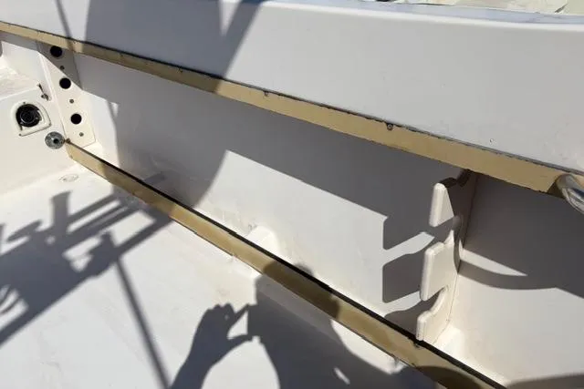 Slide: The Image of 1994 Grady-White Explorer 244 boat interior, showing white deck and side panel details. - 5