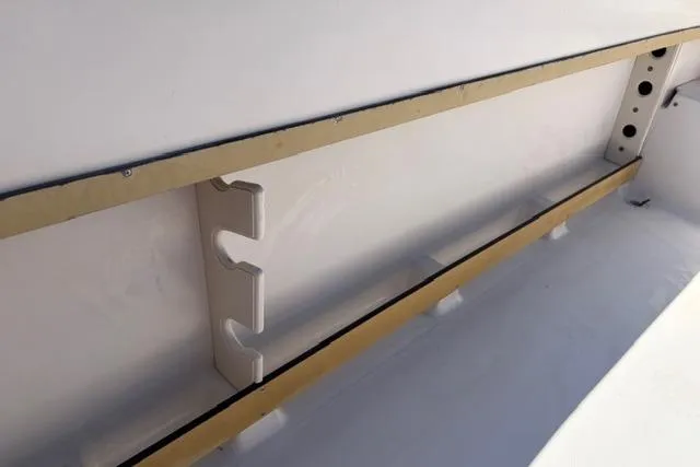 Slide: The Image of Interior view of a 1994 Grady-White Explorer 244 boat, featuring rod holders. - 6