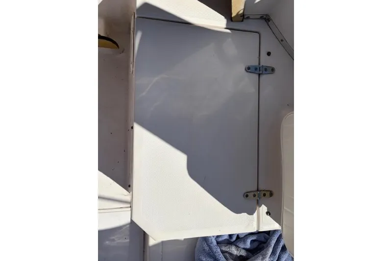 Slide: The Image of 1994 Grady-White Explorer 244 boat hatch with hinges, partially shaded. - 7