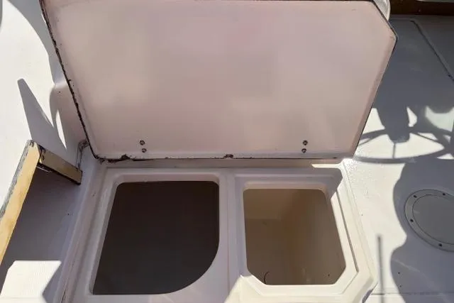 Slide: The Image of Open storage compartments on a 1994 Grady-White Explorer 244 boat deck. - 8