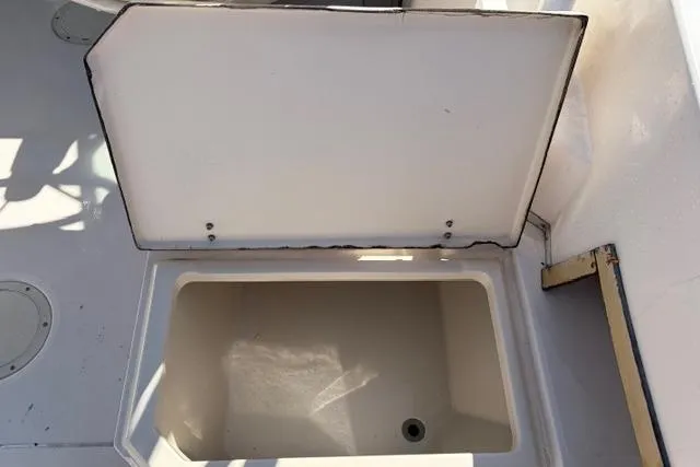 Slide: The Image of Open storage compartment on 1994 Grady-White Explorer 244 boat deck. - 9