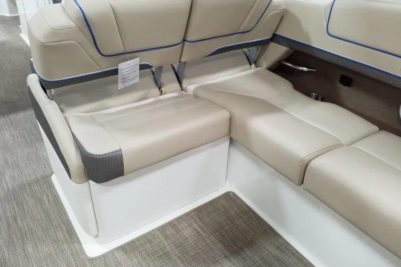 Slide: The Image of 2019 Formula 310 Bowrider interior seating with beige upholstery and blue accents. - 18