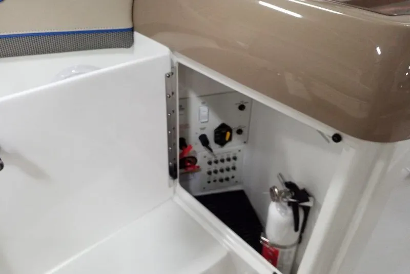 Slide: The Image of 2019 Formula 310 Bowrider storage compartment with fire extinguisher and control panel. - 22