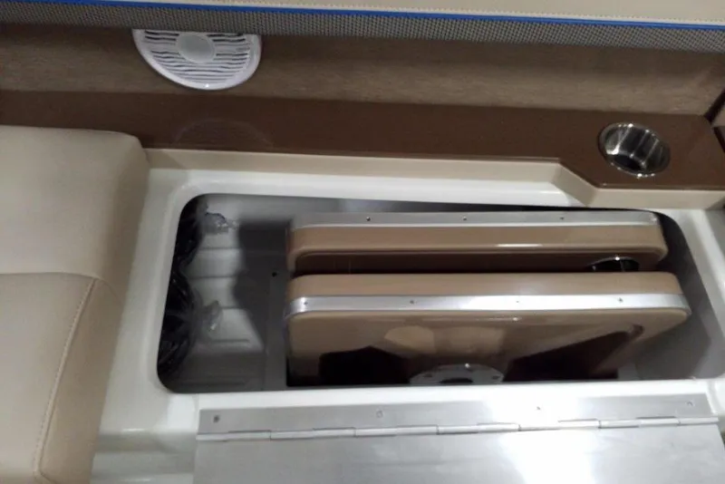 Slide: The Image of 2019 Formula 310 Bowrider storage compartment with cup holder and speaker. - 23