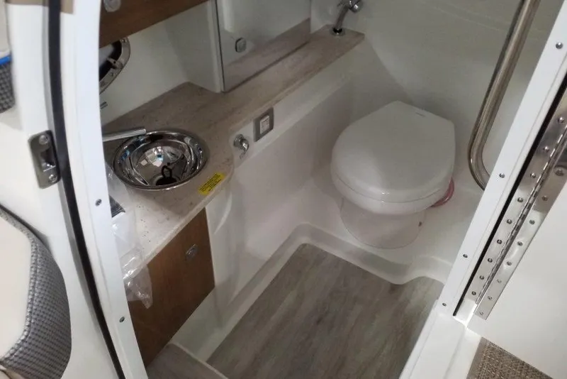 Slide: The Image of Interior of 2019 Formula 310 Bowrider boat bathroom with sink and toilet. - 25