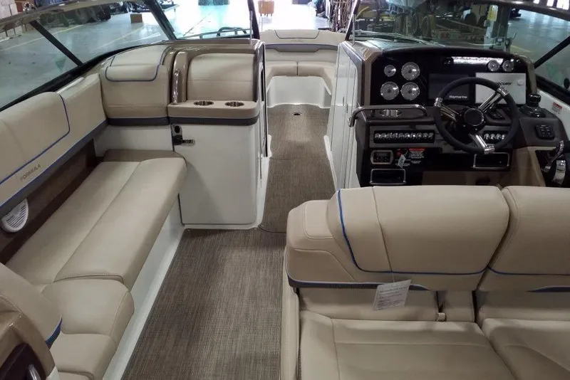 Slide: The Image of 2019 Formula 310 Bowrider interior with beige seating and modern dashboard. - 28