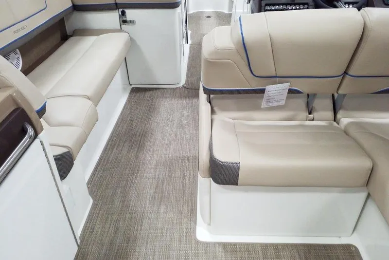 Slide: The Image of 2019 Formula 310 Bowrider interior with beige seating and carpeted flooring. - 29