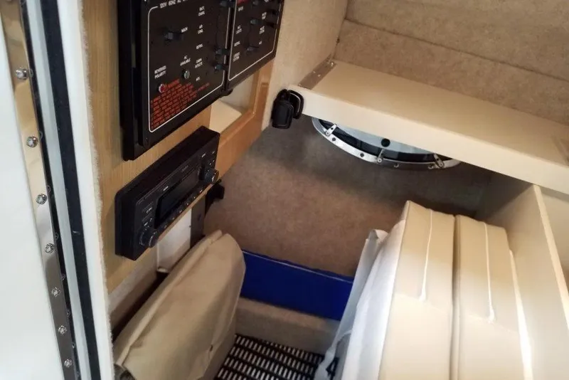 Slide: The Image of Interior view of a 2019 Formula 310 Bowrider boat cabin with control panels. - 35