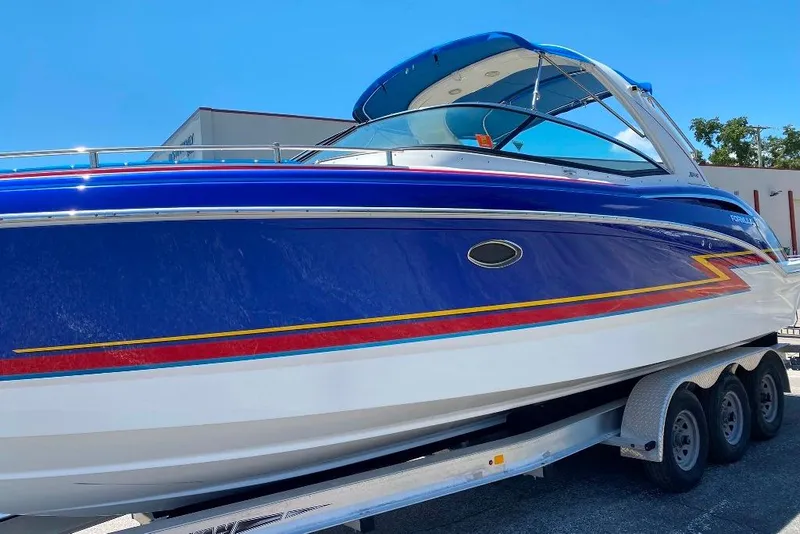 Slide: The Image of 2019 Formula 310 Bowrider boat on trailer, vibrant blue and white design. - 4