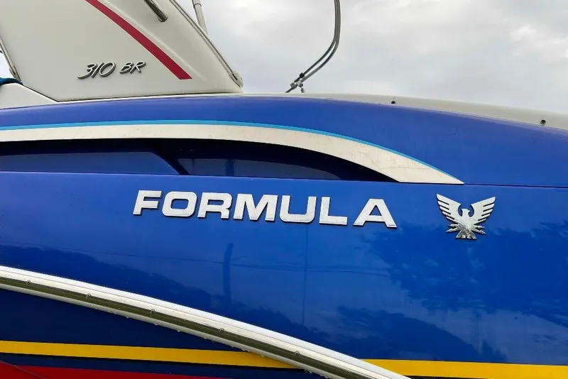 Slide: The Image of 2019 Formula 310 Bowrider boat, blue exterior with logo and emblem. - 5
