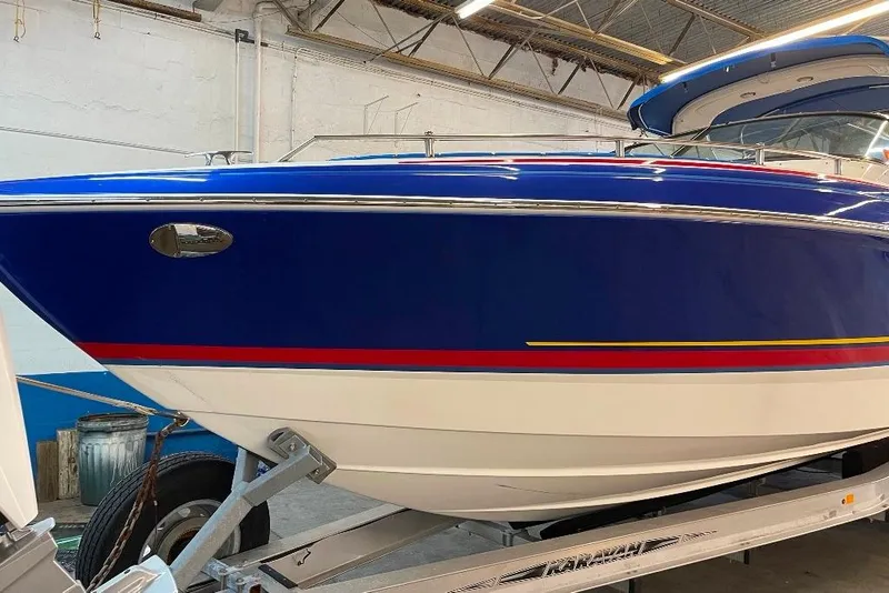 Slide: The Image of 2019 Formula 310 Bowrider boat in a spacious indoor facility. - 9