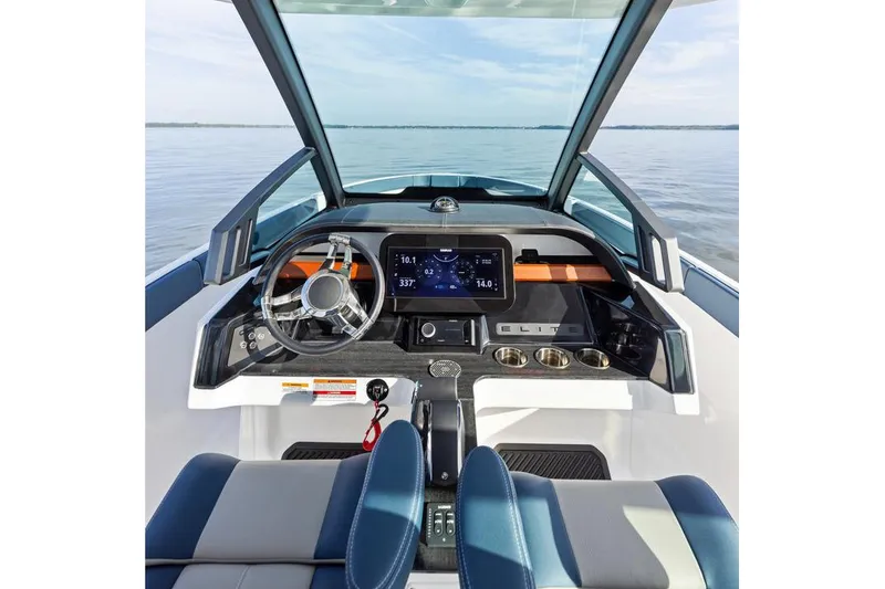 Slide: The Image of Manufacturer Provided Image: 2026 Monterey Elite 25 OB boat dashboard with modern controls and steering wheel on calm water. - 1
