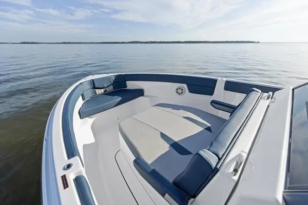 Slide: The Image of 2026 Monterey Elite 25 OB boat with spacious seating on calm water. - 8