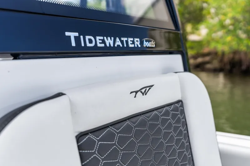 Slide: The Image of 2026 Tidewater 2500 Carolina Bay boat interior with logo detail, featuring stylish upholstery design. - 16