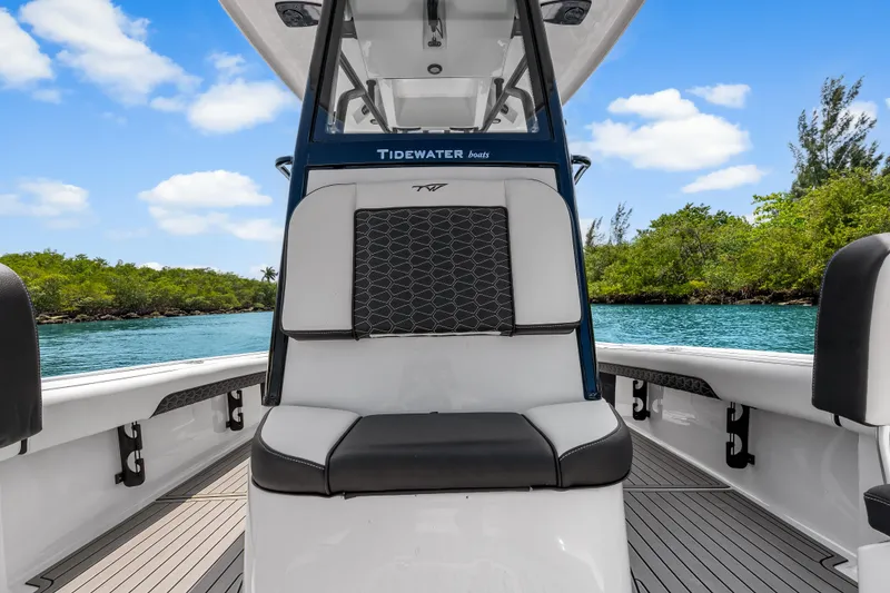 Slide: The Image of 2026 Tidewater 2500 Carolina Bay boat interior with scenic water and greenery backdrop. - 21