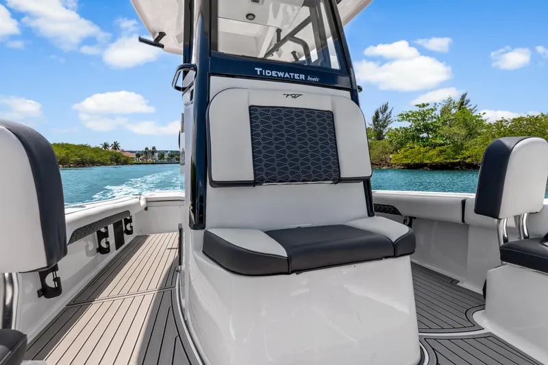 Slide: The Image of 2026 Tidewater 2500 Carolina Bay boat interior with sleek seating and scenic water view. - 22