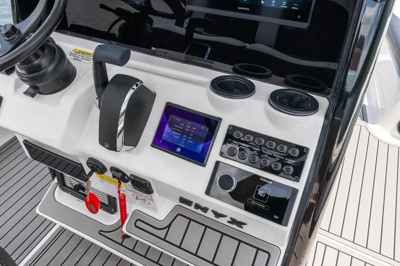 Slide: The Image of Control panel of 2026 Tidewater 2500 Carolina Bay boat with steering wheel and electronic displays. - 25