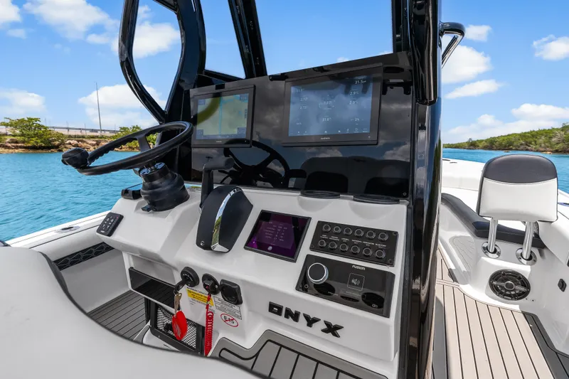 Slide: The Image of Helm of 2026 Tidewater 2500 Carolina Bay boat with advanced navigation displays. - 26