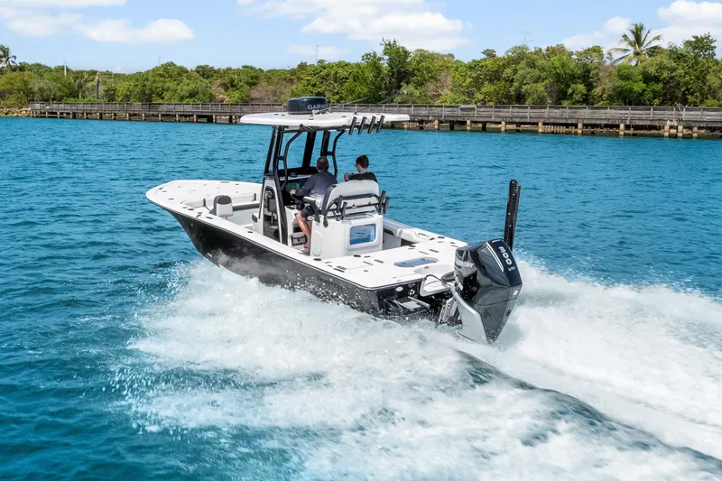 Slide: The Image of 2026 Tidewater 2500 Carolina Bay boat cruising on clear blue water. - 4