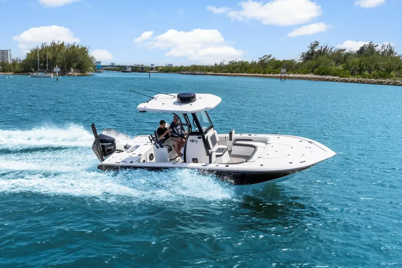 Slide: The Image of 2026 Tidewater 2500 Carolina Bay boat cruising on clear blue water. - 9