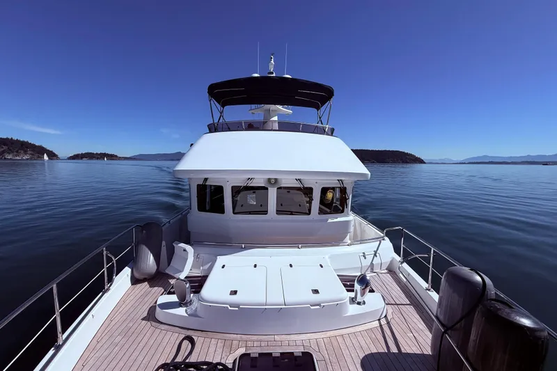 The Image of Nordhavn 52 yacht cruising on calm waters, clear blue sky, 2016 model. - 0