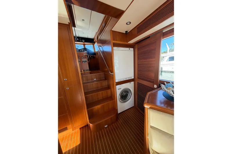 Slide: The Image of Interior of 2016 Nordhavn 52 yacht with wooden stairs and laundry appliances. - 10