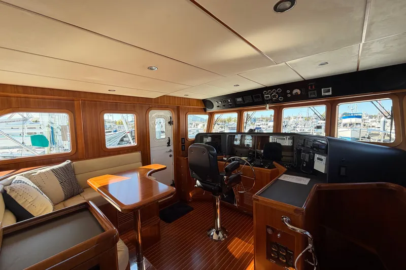 Slide: The Image of Luxurious 2016 Nordhavn 52 yacht interior with helm, seating, and wooden finishes. - 11