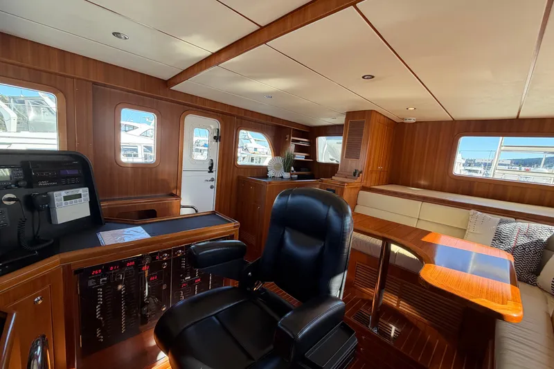 Slide: The Image of Luxurious interior of 2016 Nordhavn 52 yacht with wood paneling and plush seating. - 12