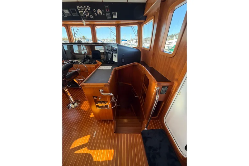 Slide: The Image of Pilothouse interior of 2016 Nordhavn 52 yacht with wooden finish and navigation equipment. - 13