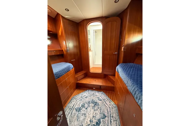 Slide: The Image of Luxurious 2016 Nordhavn 52 yacht cabin with wooden interior and blue bedding. - 15