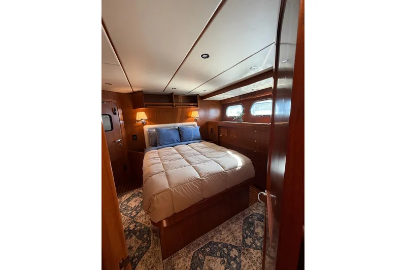 Slide: The Image of Luxurious cabin interior of 2016 Nordhavn 52 yacht with cozy bed and elegant wood finish. - 17