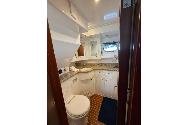 Slide: The Image of Luxurious bathroom in a 2016 Nordhavn 52 yacht with granite countertop and wooden flooring. - 19