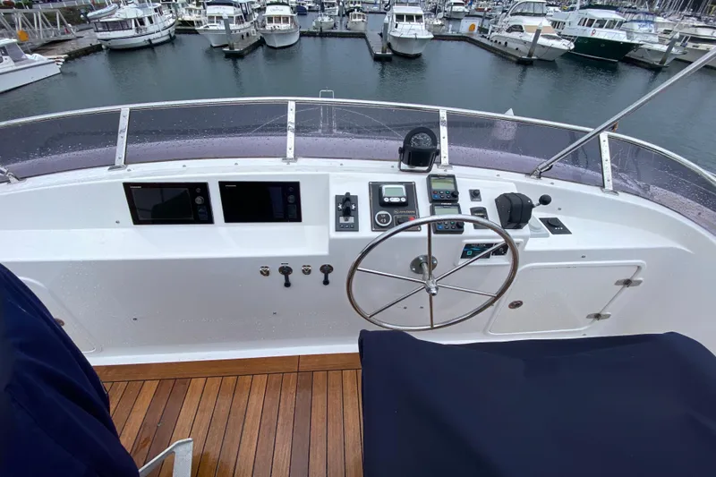 Slide: The Image of Helm of 2016 Nordhavn 52 yacht with steering wheel and navigation controls. - 2