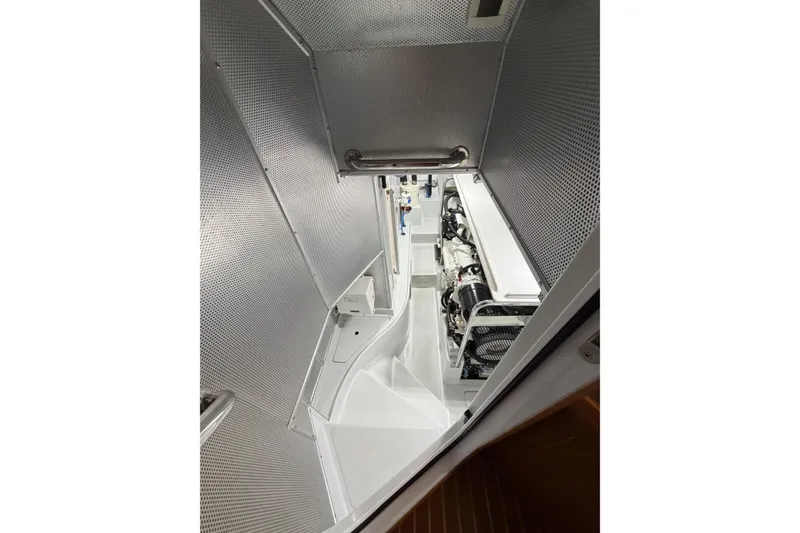 Slide: The Image of Engine room of a 2016 Nordhavn 52 yacht, featuring clean, metallic surfaces. - 21