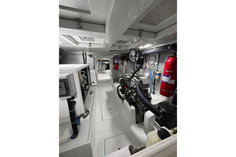 Slide: The Image of Engine room of a 2016 Nordhavn 52 yacht, featuring modern equipment and fire safety systems. - 23