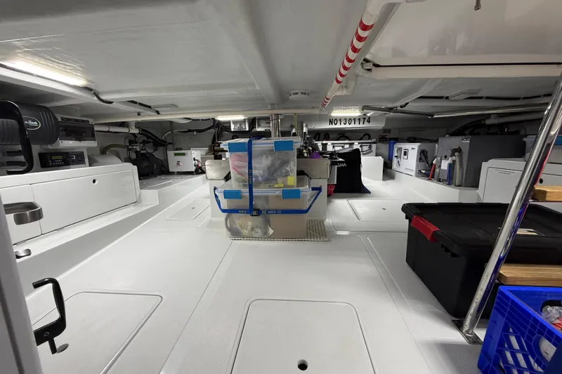 Slide: The Image of Engine room of a 2016 Nordhavn 52 yacht, showcasing organized equipment and storage. - 25