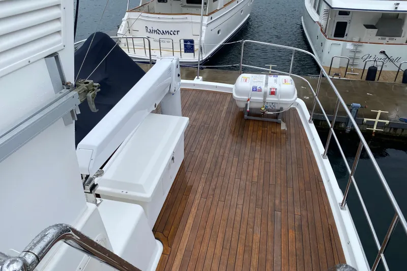 Slide: The Image of Deck view of 2016 Nordhavn 52 yacht with wooden flooring and safety equipment. - 3