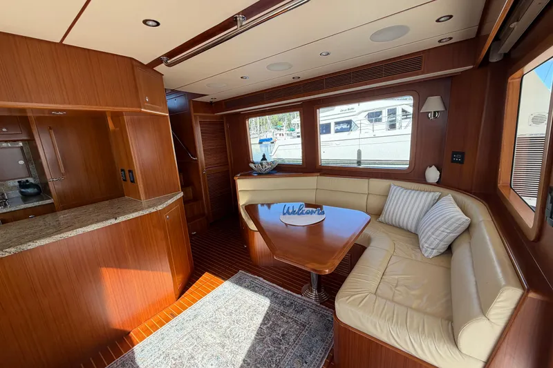 Slide: The Image of Luxurious 2016 Nordhavn 52 yacht interior with elegant wood finishes and cozy seating area. - 7